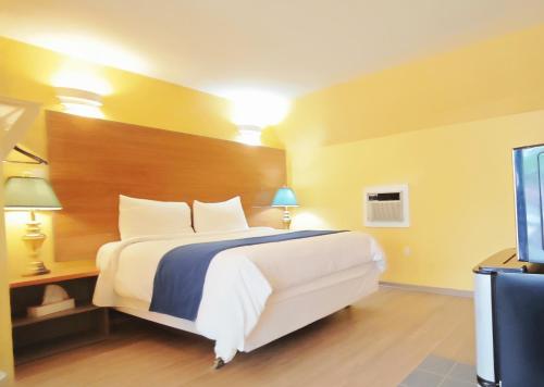 Katil atau katil-katil dalam bilik di Motel des Pentes et Suites