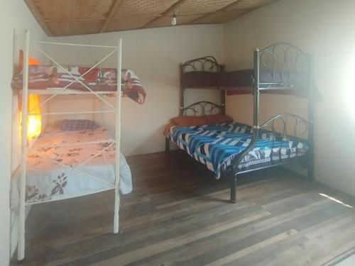 Ein Bett oder Betten in einem Zimmer der Unterkunft Hostal Casa Cotopaxi