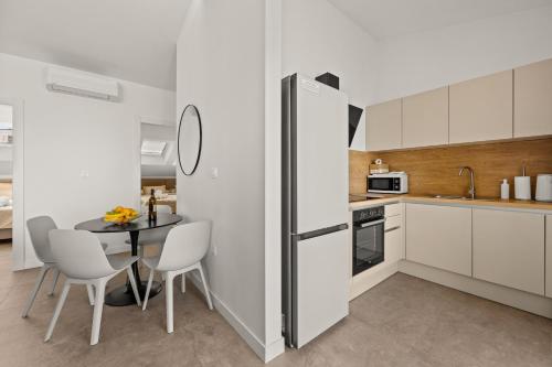 a kitchen with a table and a refrigerator at Calypso Residence in Umag