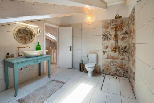 a bathroom with a blue sink and a toilet at KATINA COTTAGE in Kontogiannátika