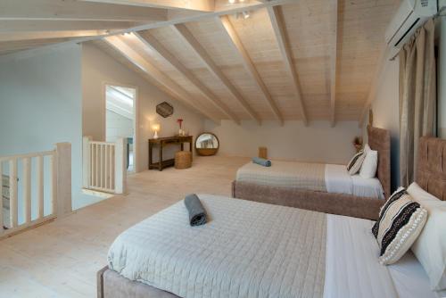 a large room with two beds and a hallway at KATINA COTTAGE in Kontogiannátika