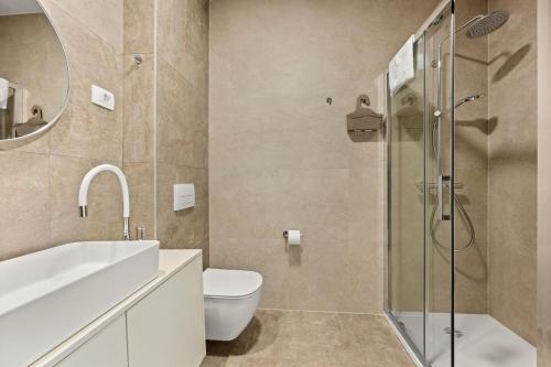 a bathroom with a sink toilet and a shower at Calypso Residence in Umag