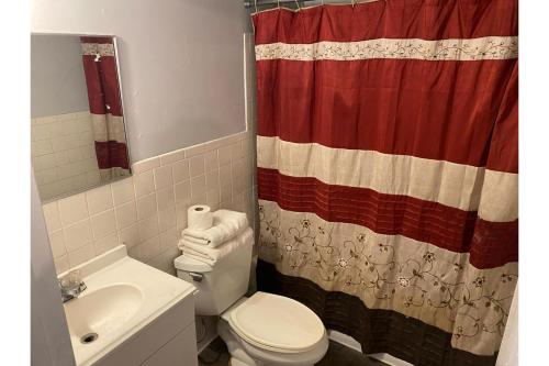a bathroom with a toilet and a shower curtain at Hotel O Englewood-South Denver CO in Englewood