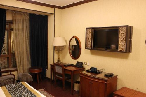 a hotel room with a television on the wall at فندق منازل المرسى Manazil almarsa in Al Madinah