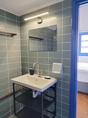 a bathroom with a sink and a mirror at 2P studio in Skiathos