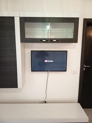 a flat screen tv on a wall in a room at Elegant Studio Militari Private Parking Self check in Netflix New building in Bucharest