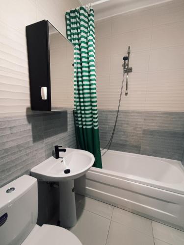 a bathroom with a sink and a toilet and a tub at Elegant Studio Militari Private Parking Self check in Netflix New building in Bucharest