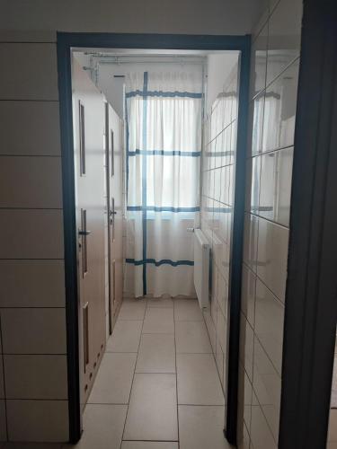 a hallway with two doors and a tile floor at Siedlisko na łące in Dąbrówno