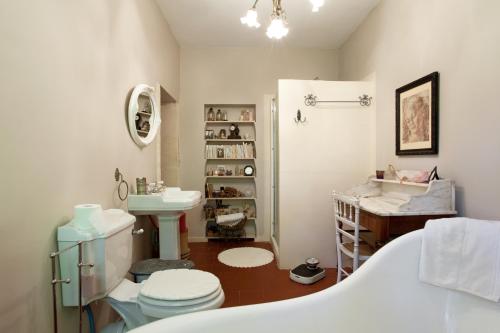 une salle de bain avec une baignoire, des toilettes et un lavabo dans l'établissement Le Mas de l'Embellie, à Arles