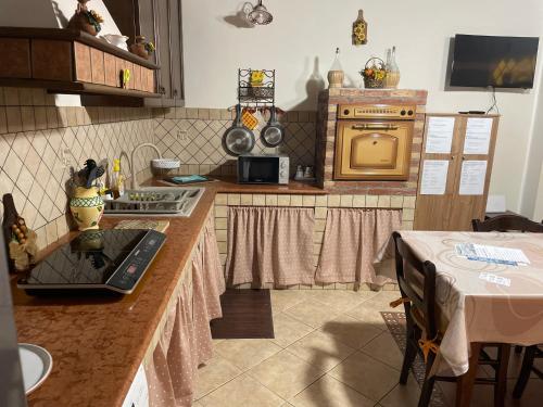 a kitchen with a counter with a laptop on it at Sea Living Sicilia Apartment in Santa Flavia