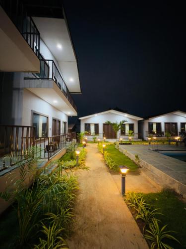 a courtyard of a building at night with lights at La Utopia Resort in Arambol