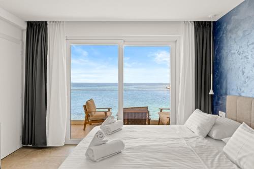 a bedroom with a bed with a view of the ocean at Calypso Residence in Umag