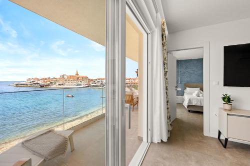 a bedroom with a view of the ocean at Calypso Residence in Umag