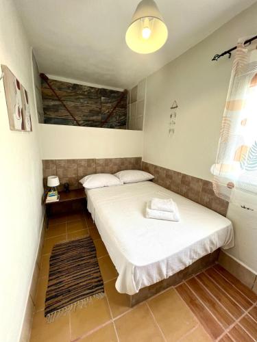 a room with two beds and a window at Cottage near the sea in Nea Moudania