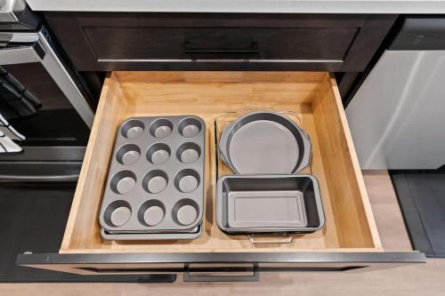 a drawer in a microwave with a tray of remotes at Stunning 3-Bed Retreat in the Heart of Downtown in Spokane
