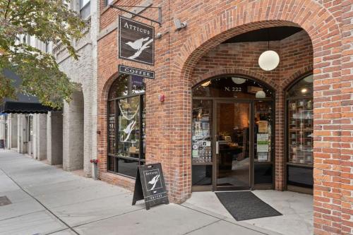 a brick building with an entrance to a store at Stunning 3-Bed Retreat in the Heart of Downtown in Spokane