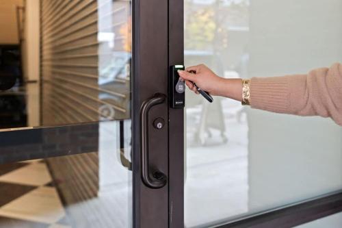 a person opening a glass door with their hand at Stunning 3-Bed Retreat in the Heart of Downtown in Spokane