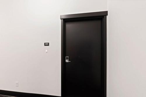 a black elevator door in a white wall at Stunning 3-Bed Retreat in the Heart of Downtown in Spokane