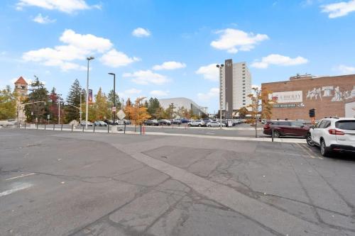 an empty parking lot with cars parked on the street at Stunning 3-Bed Retreat in the Heart of Downtown in Spokane