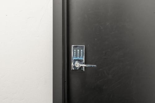 a black refrigerator with a door with a handle at Modern Luxury - 3 Bed in the Heart of Downtown in Spokane