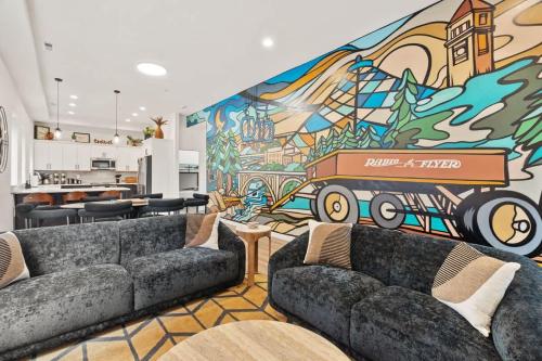 a living room with couches and a mural at Modern Luxury - 3 Bed in the Heart of Downtown in Spokane