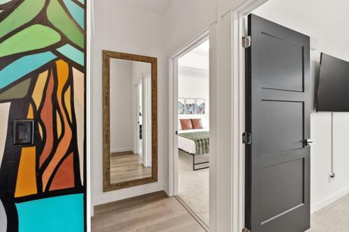 a hallway with a door and a painting on the wall at Modern Luxury - 3 Bed in the Heart of Downtown in Spokane