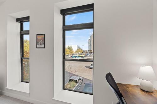 a room with a window and a table with a lamp at Modern Luxury - 3 Bed in the Heart of Downtown in Spokane