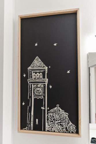 a drawing of a clock tower on a black wall at Modern Luxury - 3 Bed in the Heart of Downtown in Spokane