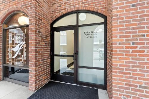 a brick wall with glass doors on a building at Modern Luxury - 3 Bed in the Heart of Downtown in Spokane
