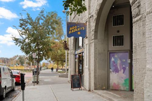 a building with a sign on the side of a street at Modern Luxury - 3 Bed in the Heart of Downtown in Spokane