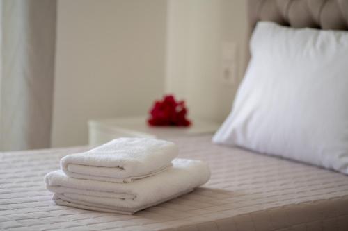 a pile of towels sitting on top of a bed at Casa Luna in Patitiri