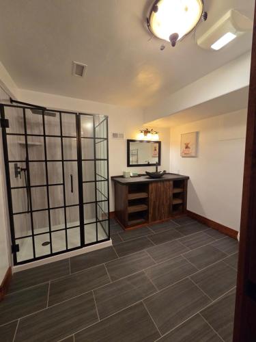 a room with a bathroom with a sink and a mirror at Kennymores Grill and Lodging in Cedaredge