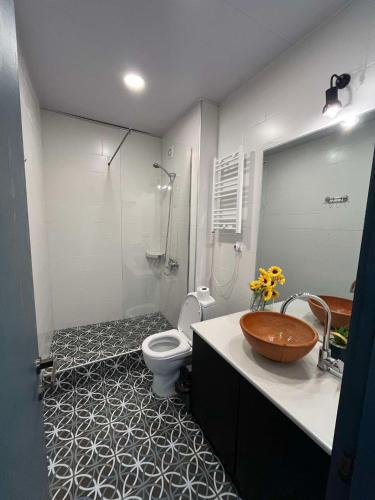 a bathroom with a sink and a toilet and a mirror at Bakuriani Bliss Apartment in Bakuriani