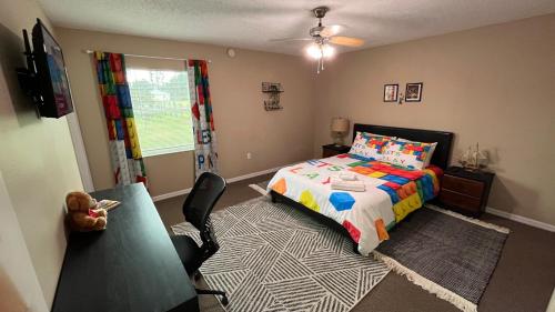 a bedroom with a bed and a chair in it at BlockHaven near Legoland, Disney in Winter Haven
