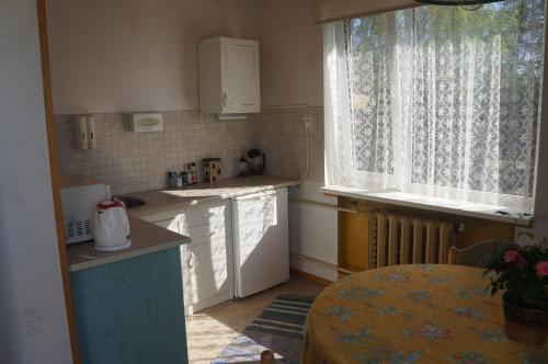 a small kitchen with a table and a window at VIIVE KONI Home Accommodation in Tartu