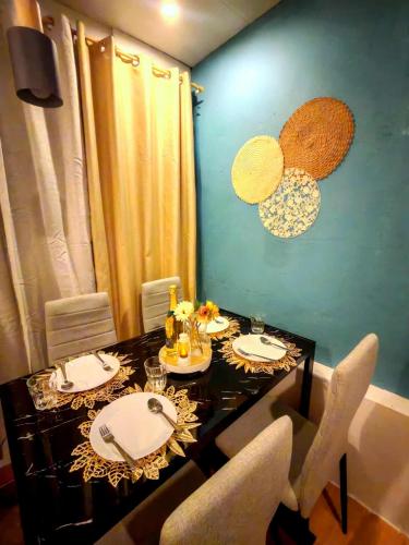 a dining room with a table with chairs and a tableablish at Rizal Paragliding Zone - R&G Staycation in Binangonan