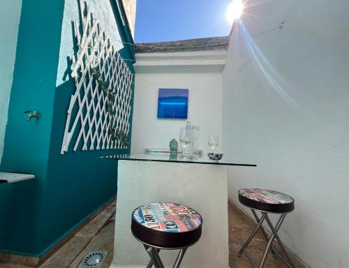 a bar with two stools in a room at Maison des Remparts in Céret