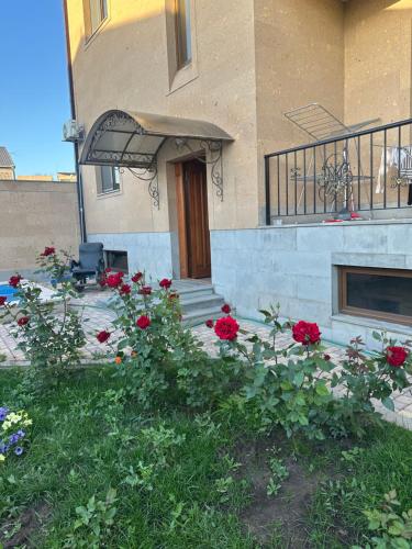 a house with red flowers in front of it at General guesthouse in Yerevan