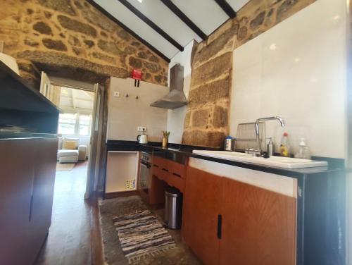 a kitchen with a sink and a counter at Quinta de Gonçalo in Guarda