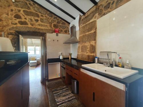a kitchen with a sink and a counter top at Quinta de Gonçalo in Guarda