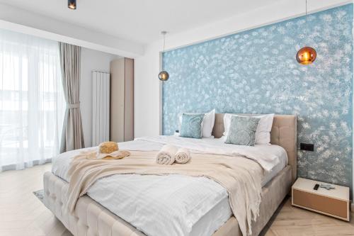 a bedroom with a large bed with two towels on it at Riviera - Infinity Pool & Spa Resort in Mamaia
