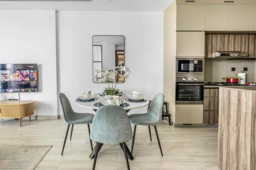 a dining room with a table and chairs at Comfy 1BR w Cinema Room Business Centre Pool Table and Sauna in Dubai