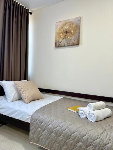a bedroom with a bed with towels on it at apartments in Ternopil city in Ternopilʼ