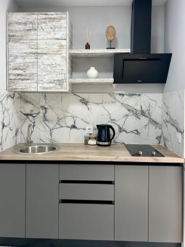 a kitchen with a sink and a counter top at apartments in Ternopil city in Ternopilʼ