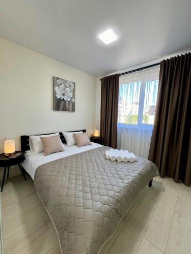a bedroom with a large bed and a large window at apartments in Ternopil city in Ternopilʼ