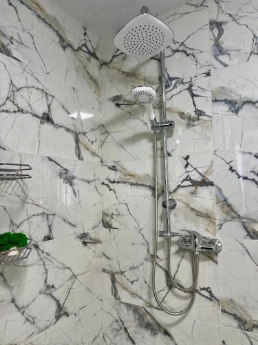 a shower with a shower head in a bathroom at apartments in Ternopil city in Ternopilʼ