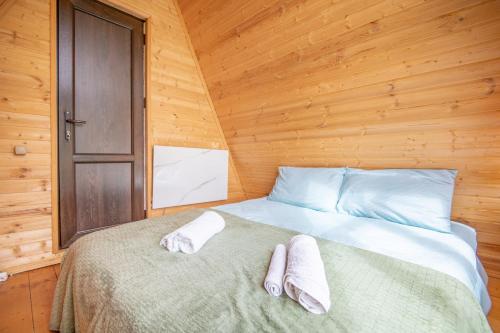 a bedroom with a bed with two towels on it at MOUNTAIN CABIN in Ushguli
