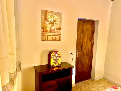a room with a wooden table with a clock on it at Civico 31 in Terralba
