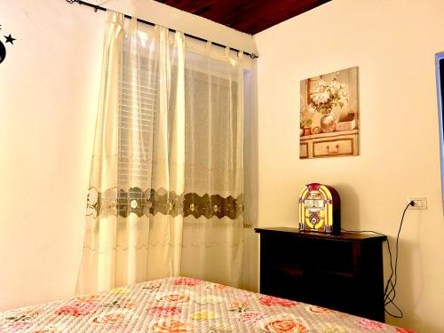 a bedroom with a bed and a window at Civico 31 in Terralba