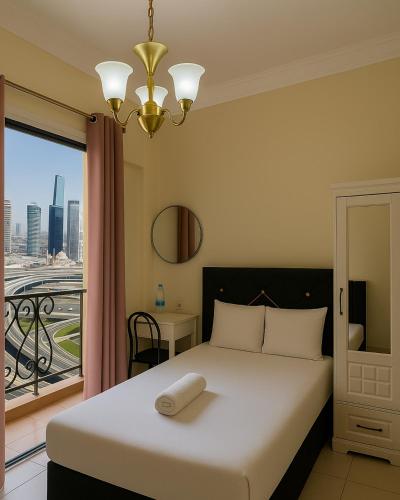 a bedroom with a bed and a window with a view at TGB Compact Home JBR Marina Manchester Tower in Dubai